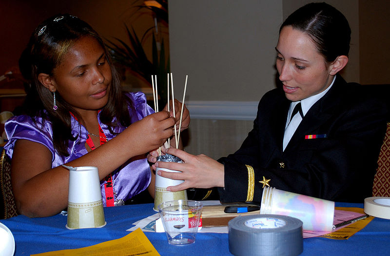 800px-US_Navy_090326-N-9268E-003_Ensign_Natalie_Alford_helps_a_student_during_a_science_competition_at_the_National_Society_of_Black_Engineers_conference_in_Las_Vegas