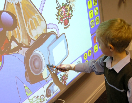 A Student Uses an Interactive Whiteboard