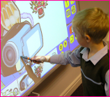 A Student Uses an Interactive Whiteboard