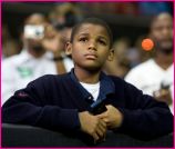 Young Student Listens to President Obama Speak