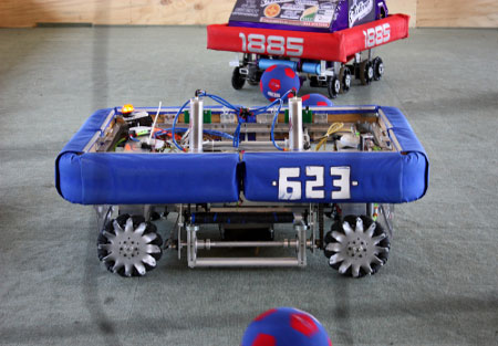 Robots from FIRST Robotics Spar During a Soccer Game