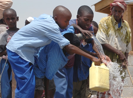 Children in Africa Pour Fresh, Clean Water into Jugs