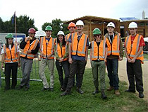 Photo: Team New Zealand, from Victoria University of Wellington, take a late lunch break from assembling First Light, a solar version of the traditional "Kiwi bach" vacation house framed with sustainably grown Canadian cedar and New Zealand wood interior.